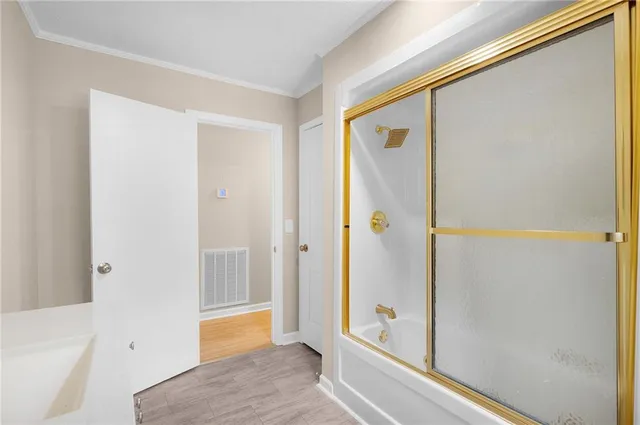 a bathroom with a bathtub and a shower