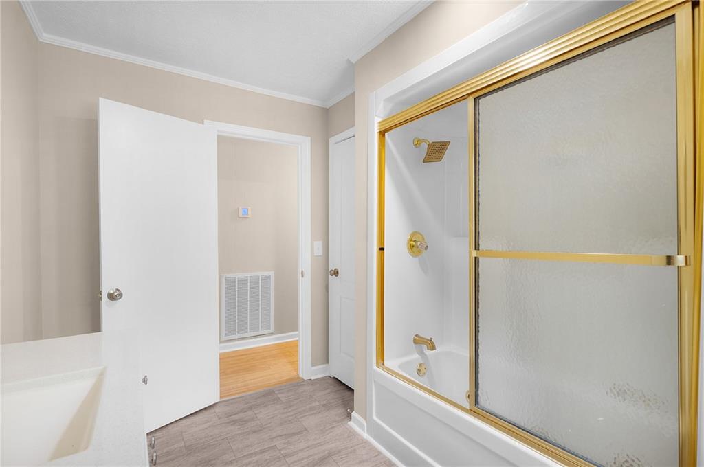 111 Nike Drive Calhoun, GA 30701 - Photo 19 of 36 a bathroom with a bathtub and a shower