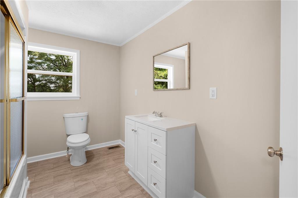 111 Nike Drive Calhoun, GA 30701 - Photo 20 of 36 a bathroom with a toilet sink and window