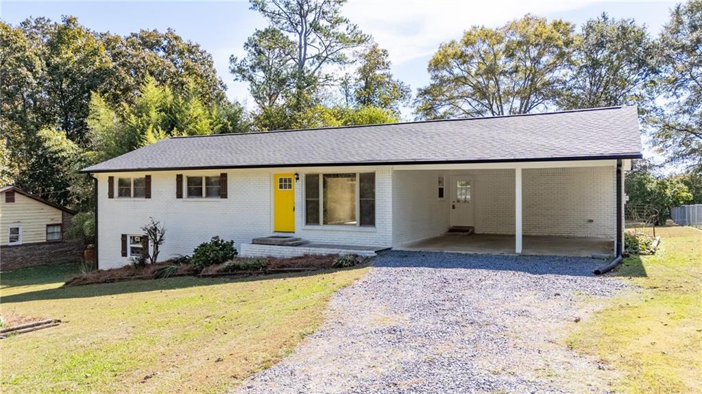 111 Nike Drive Calhoun, GA 30701 - Photo 2 of 36 a front view of a house with a yard and garage