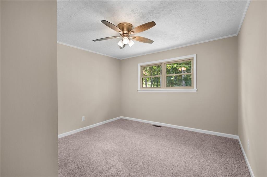 111 Nike Drive Calhoun, GA 30701 - Photo 21 of 36 an empty room with windows and fan