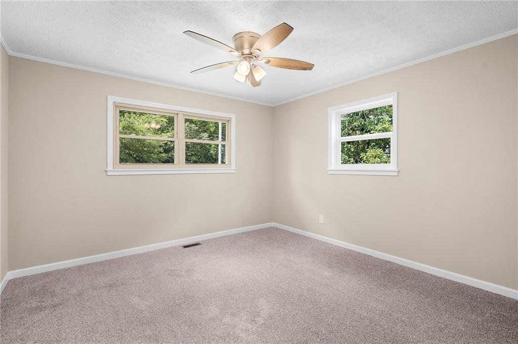 111 Nike Drive Calhoun, GA 30701 - Photo 22 of 36 an empty room with a window and a fan