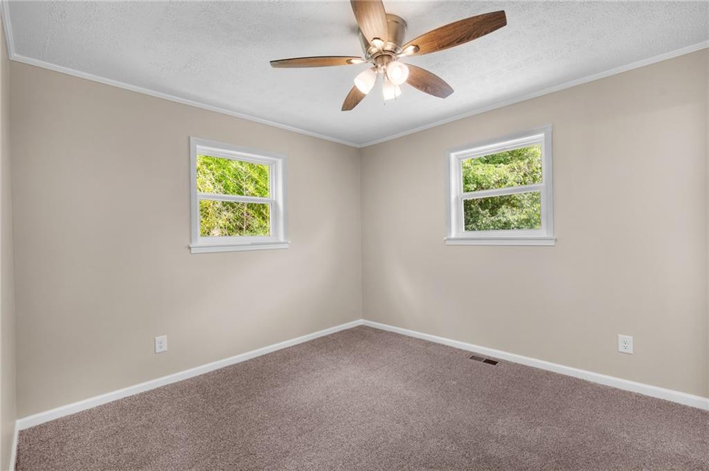 111 Nike Drive Calhoun, GA 30701 - Photo 23 of 36 an empty room with a window and a fan