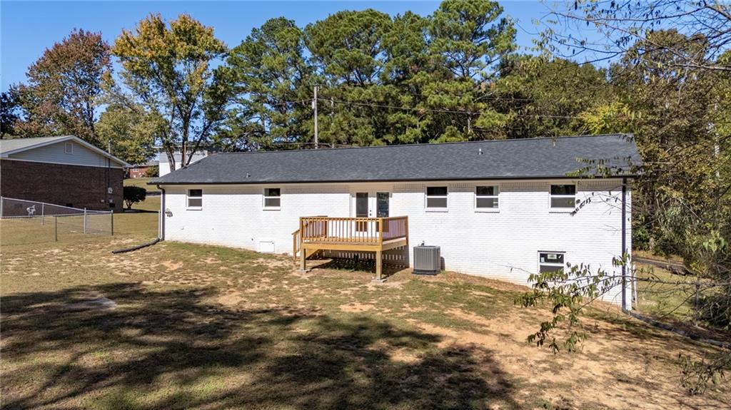 111 Nike Drive Calhoun, GA 30701 - Photo 32 of 36 a backyard of a house with table and chairs