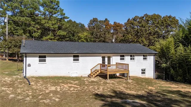 a view of a white house with a yard