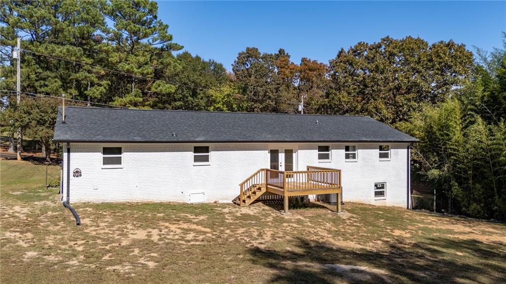 111 Nike Drive Calhoun, GA 30701 - Photo 33 of 36 a view of a white house with a yard