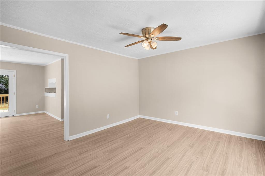 111 Nike Drive Calhoun, GA 30701 - Photo 9 of 36 a view of a room with wooden floor and a ceiling fan