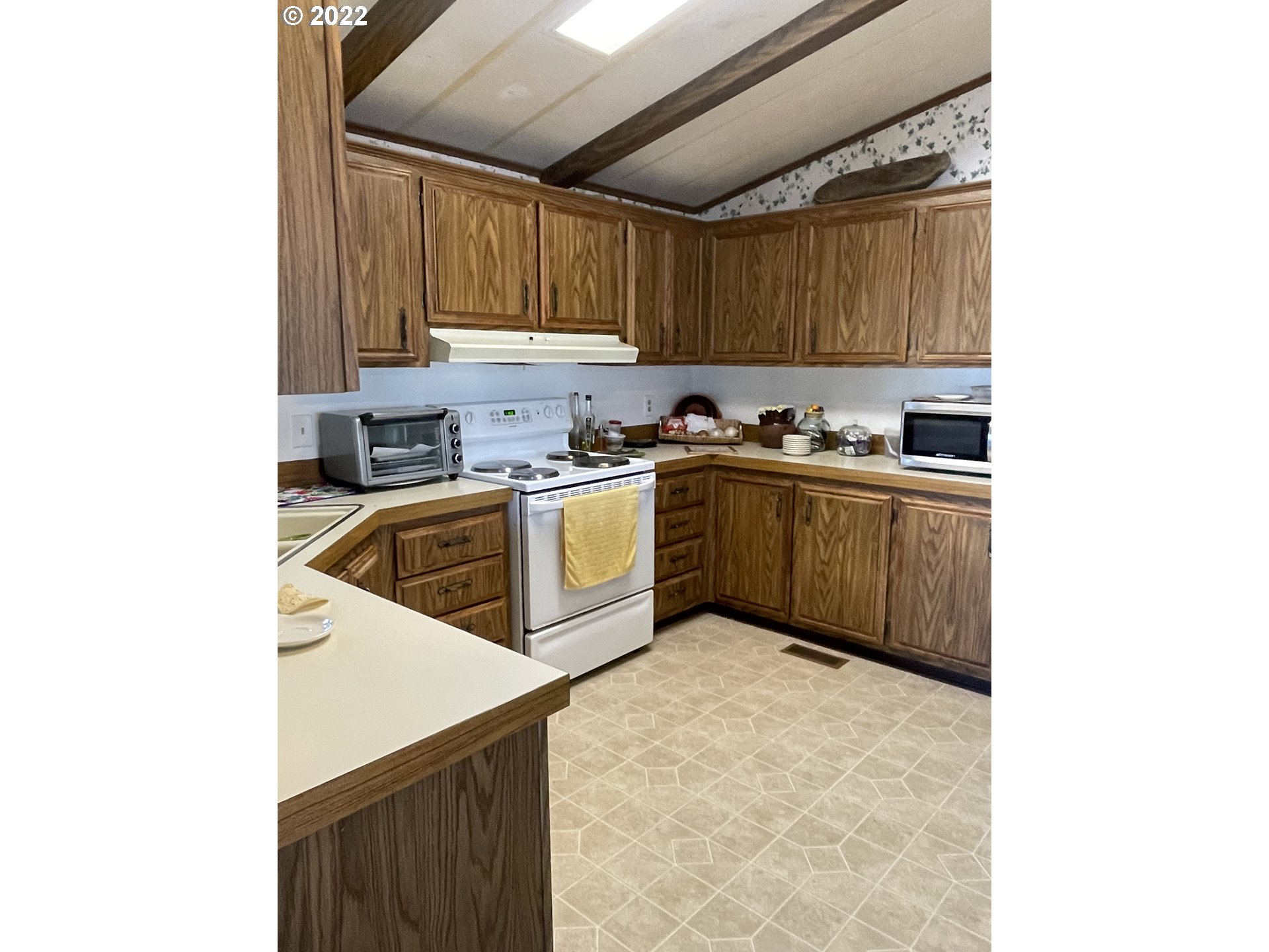 2150 Laura Street, Unit 115 Springfield, OR 97477 - Photo 4 of 19 a kitchen with a sink cabinets and a window