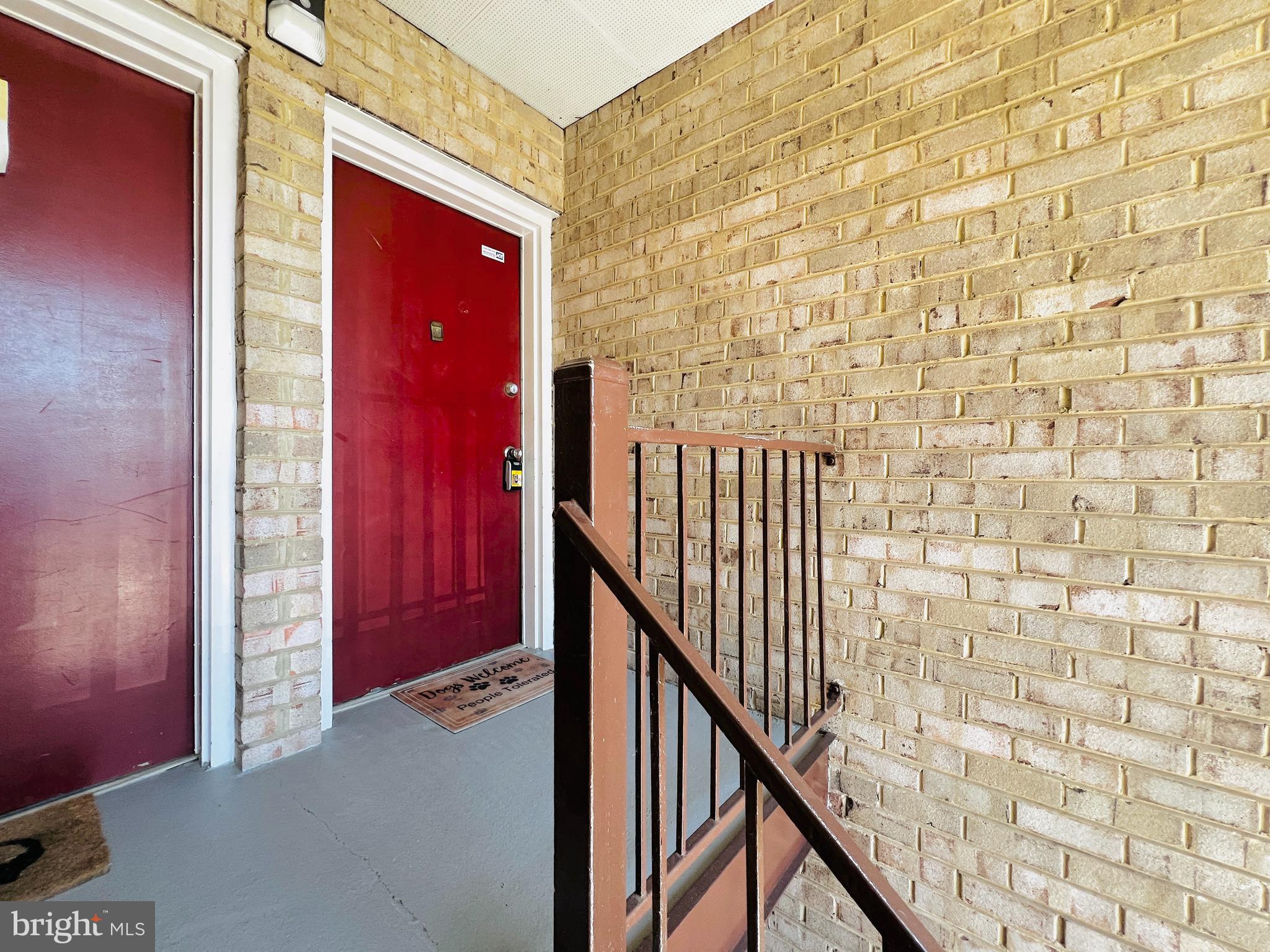 8665 Greenbelt Road, Unit 202 Greenbelt, MD 20770 - Photo 2 of 22 a view of a hallway with wooden floor and staircase