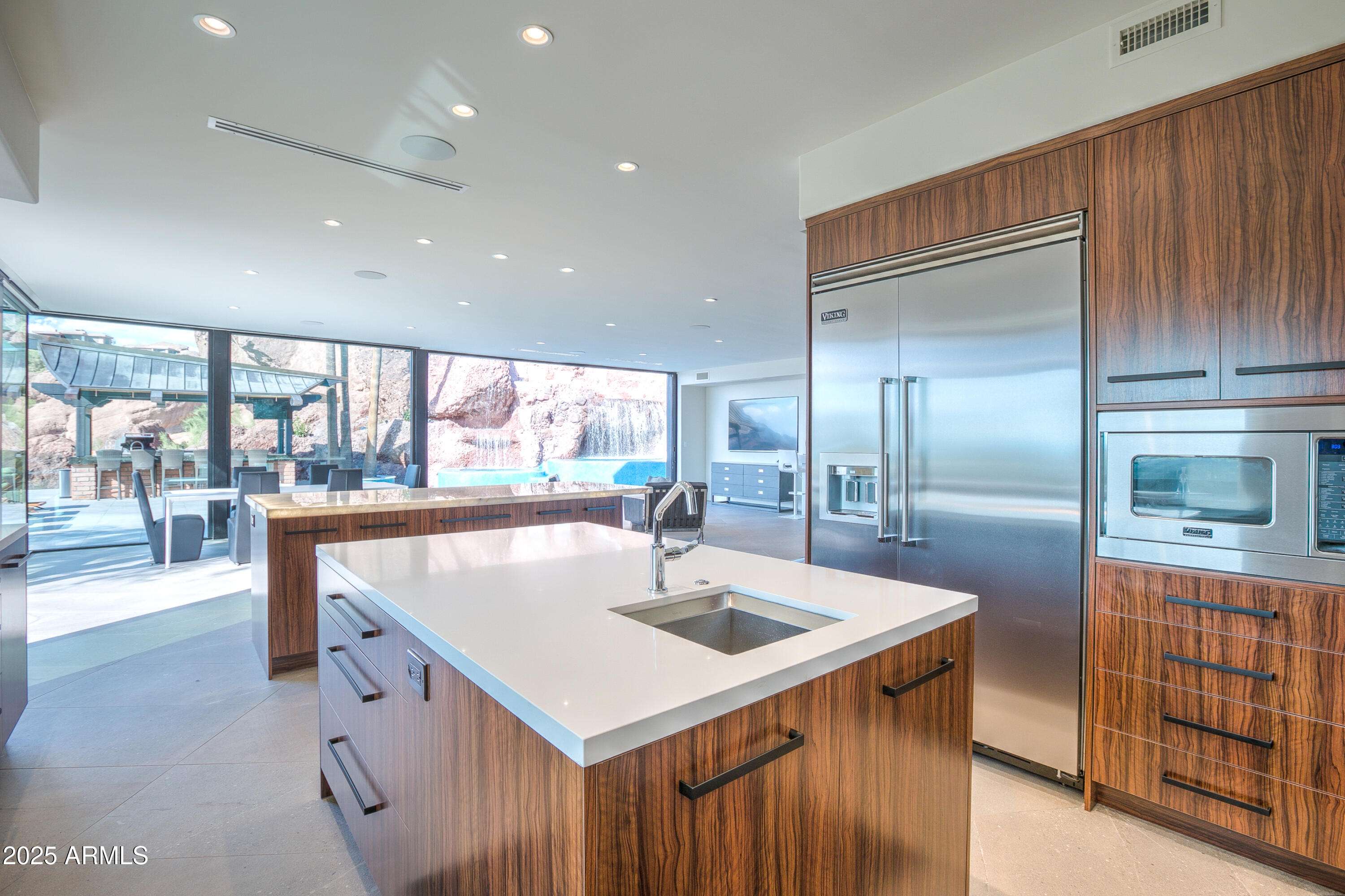 5302 North 47th Street Phoenix, AZ 85018 - Photo 13 of 33 a kitchen with stainless steel appliances granite countertop a sink and a refrigerator
