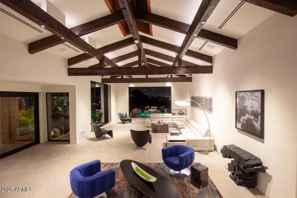 a living room with furniture and a floor to ceiling window
