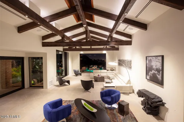 a living room with furniture and a floor to ceiling window