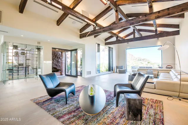 a bedroom with a large bed and a large window with outer view