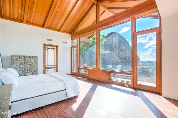 a bedroom with a large bed and a large window