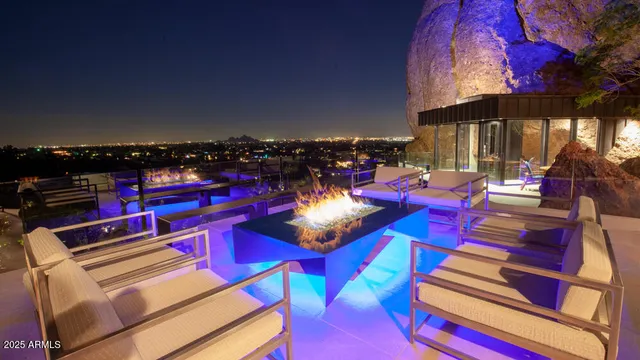 a view of a balcony with chairs and a potted plant