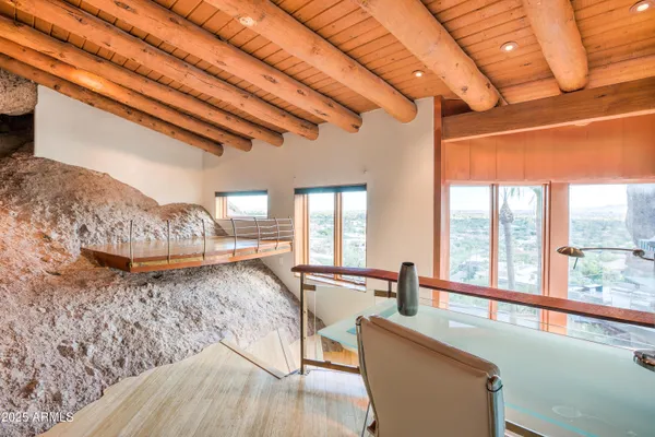 a bedroom with a large window and a bed