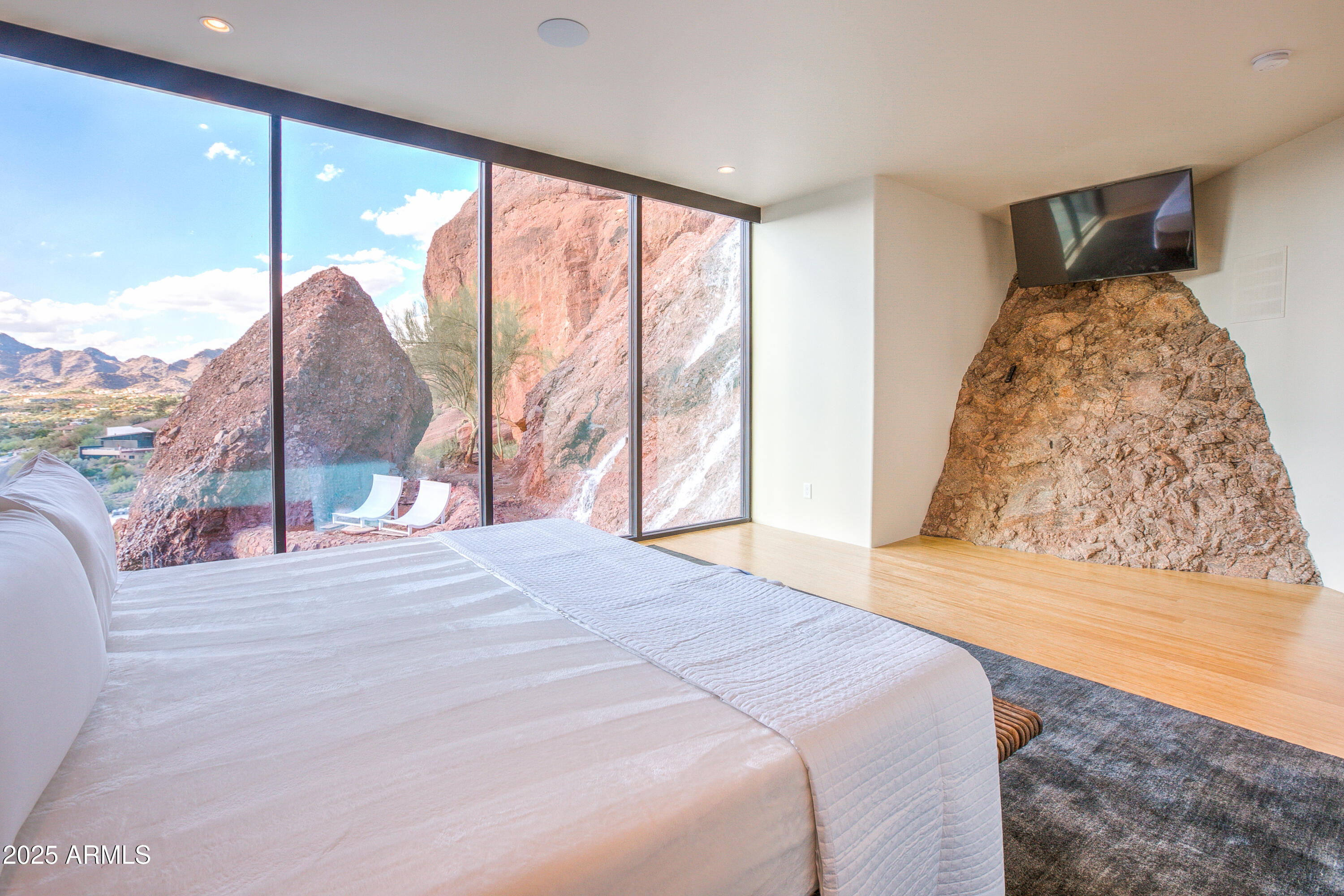 5302 North 47th Street Phoenix, AZ 85018 - Photo 25 of 33 a bedroom with a large window and a bed