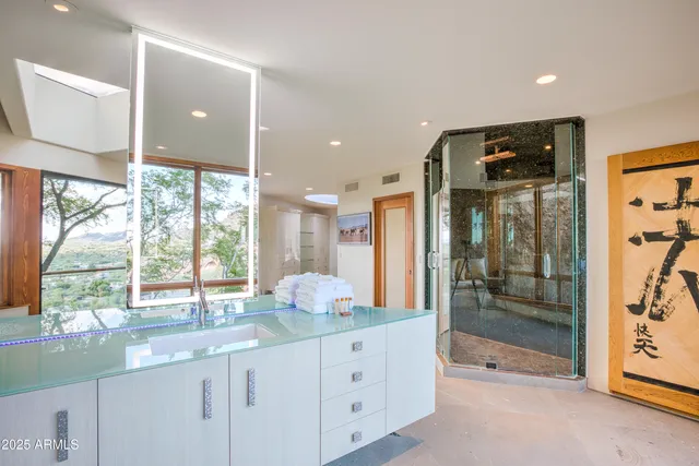 a bathroom with a tub sink and mirror