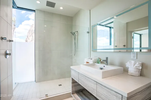 a dining room with furniture and a large window