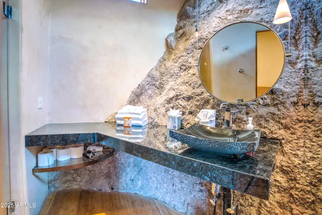 an aerial view of a house with a garden and lake view