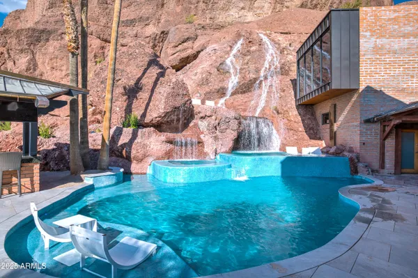 a view of a chairs and table in backyard