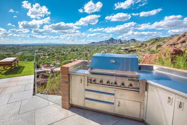 a living room with patio furniture and a flat screen tv