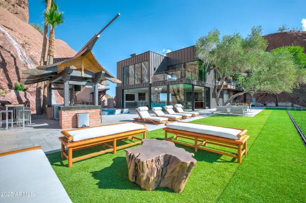 a balcony with wooden floor and outdoor seating