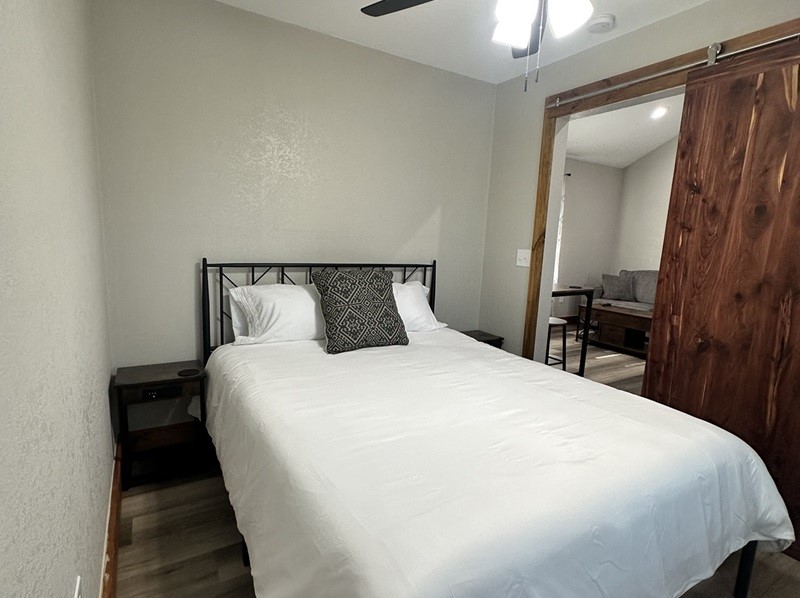 4326 Highway 19 Trinity, TX 75862 - Photo 11 of 12 a large bed sitting in a bedroom and a mirror