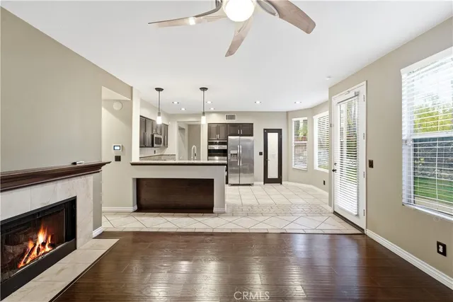 a living room with furniture a fireplace and wooden floor