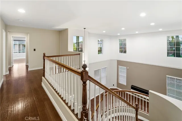 a view of staircase with wooden floor and fan