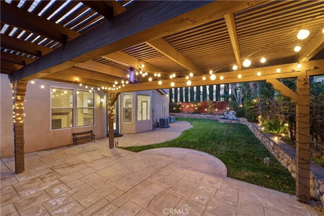 a view of a porch with a table and chairs under an umbrella
