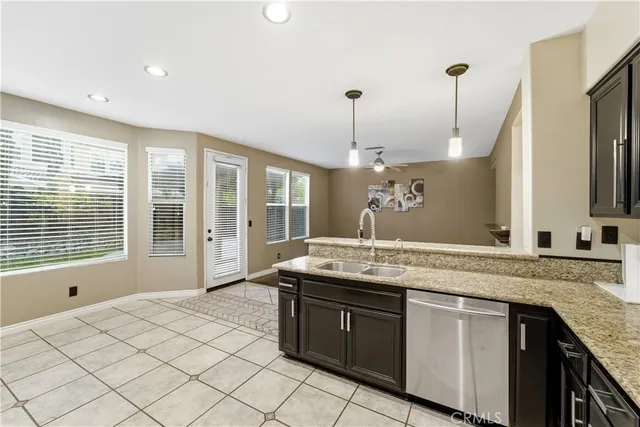 a kitchen with stainless steel appliances granite countertop a sink and a granite counter tops
