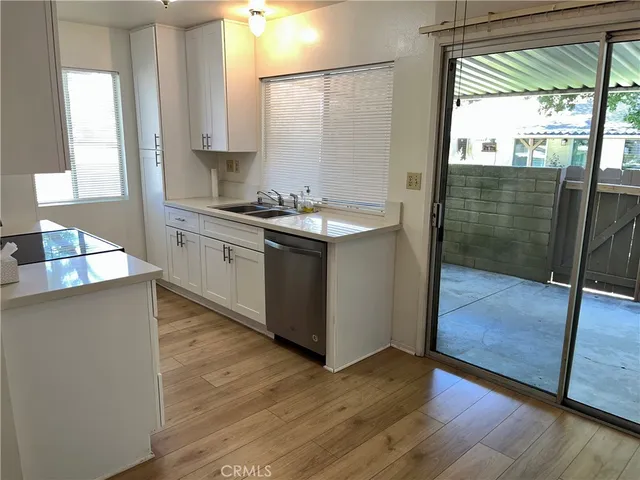 a kitchen with granite countertop a sink and a stove
