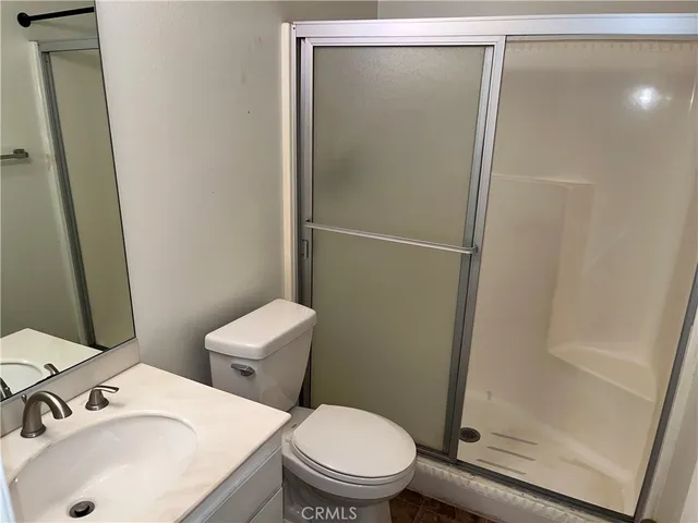 a white toilet sitting next to a bathroom sink