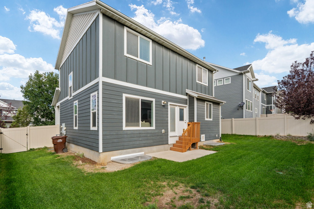 7822 North Copperbend Road Eagle Mountain, UT 84005 - Photo 46 of 46 Rear exterior featuring gray horizontal siding, vertical siding, white trim, a concrete patio, and a wooden staircase