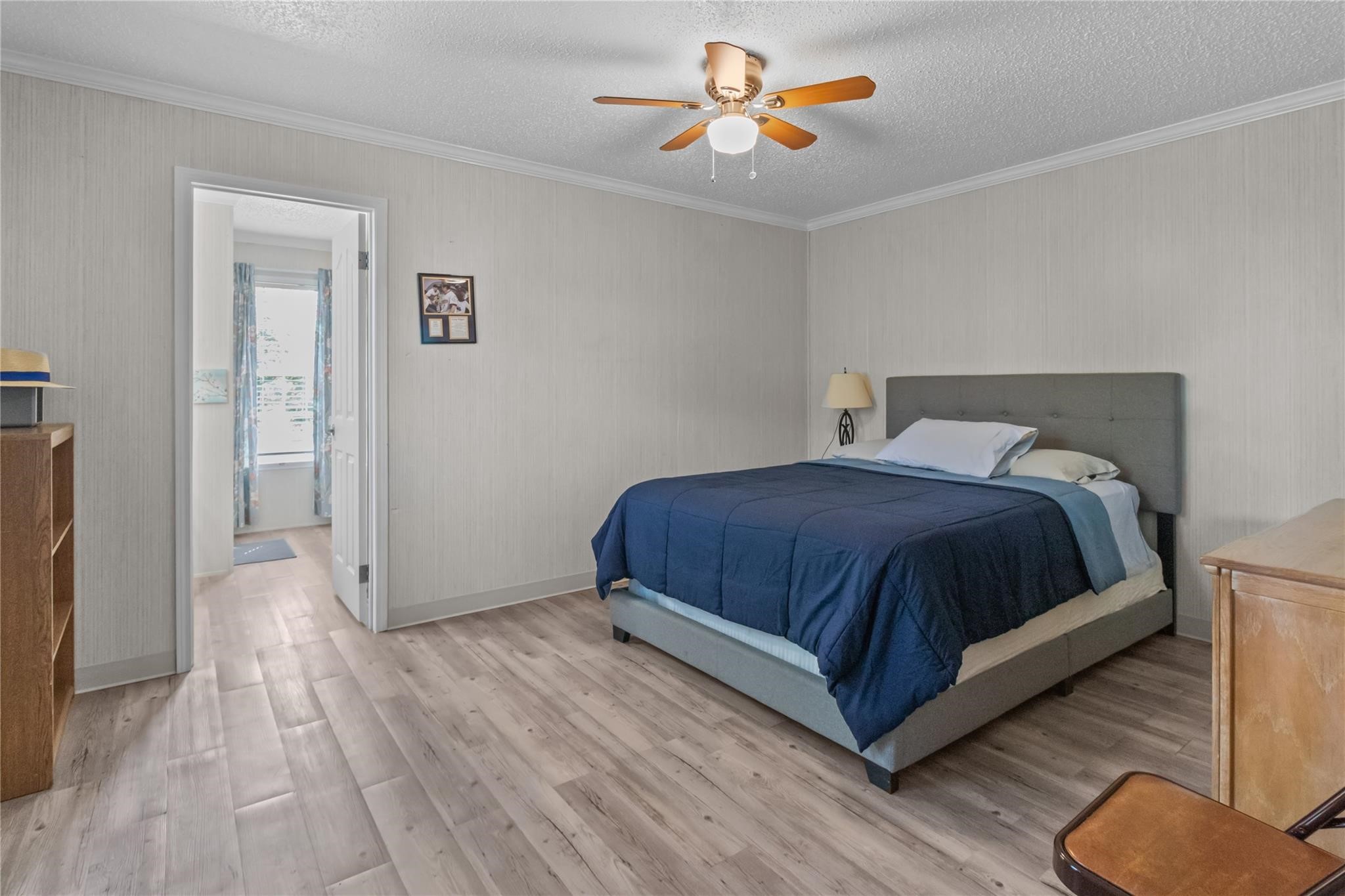 845 County Road 281 Sargent, TX 77414 - Photo 14 of 22 a bedroom with a bed and wooden floor