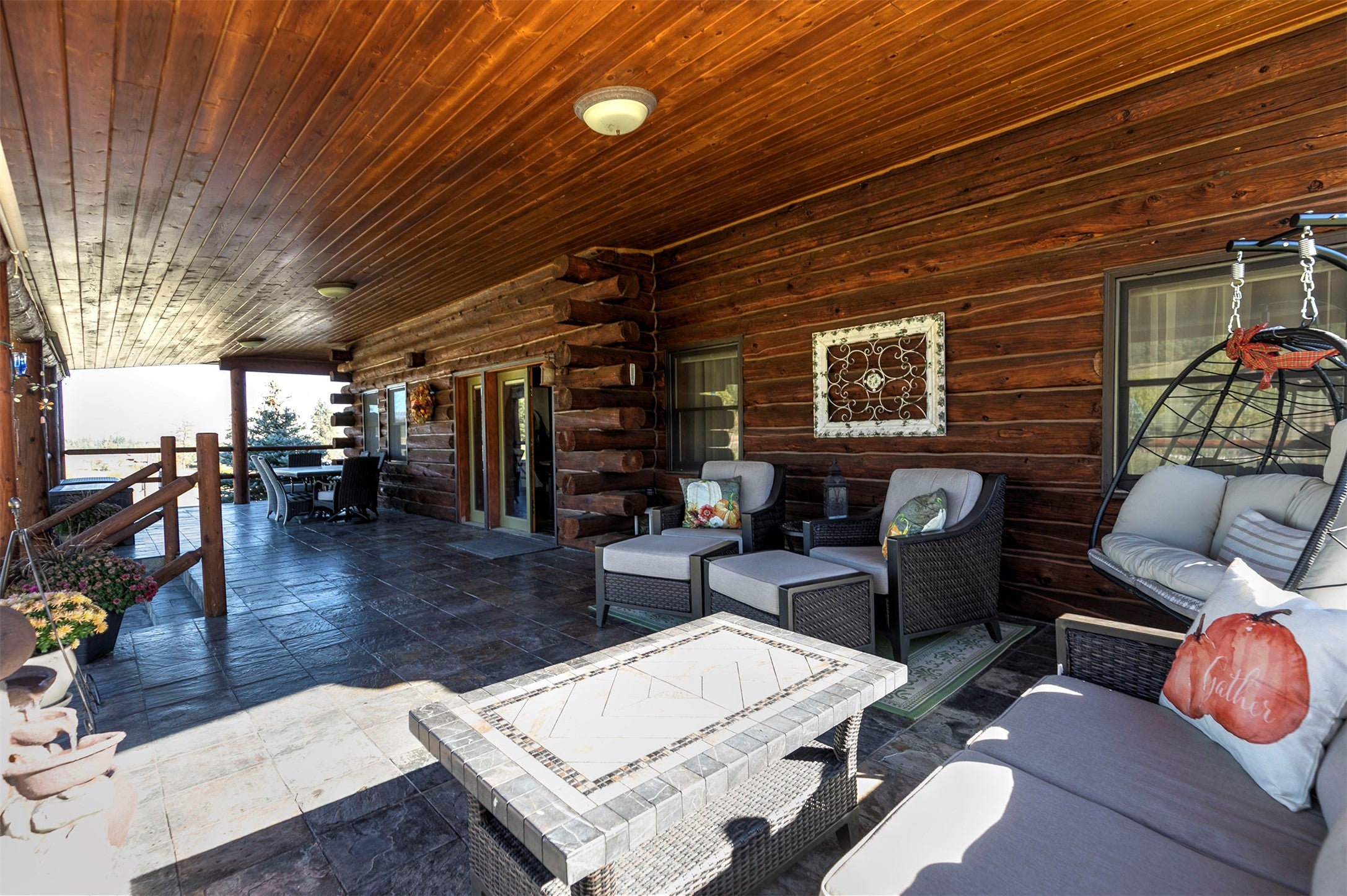 203 Hart Bench Road Darby, MT 59829 - Photo 32 of 56 The expansive, covered deck provides an inviting space for family and friends to gather, offering comfort and enjoyment in every season.