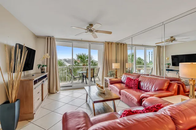 a living room with furniture a flat screen tv and a large window