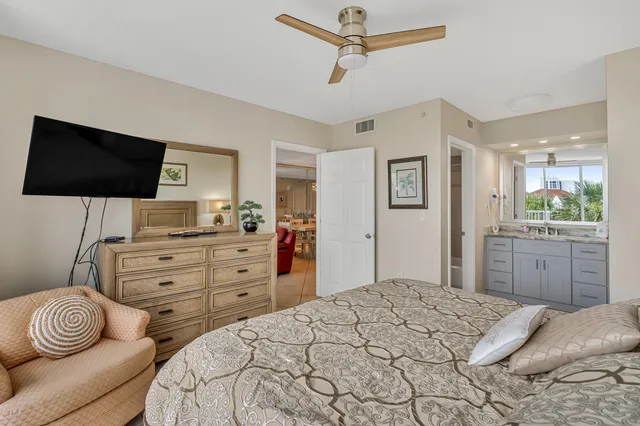 a bedroom with a bed a window and a television