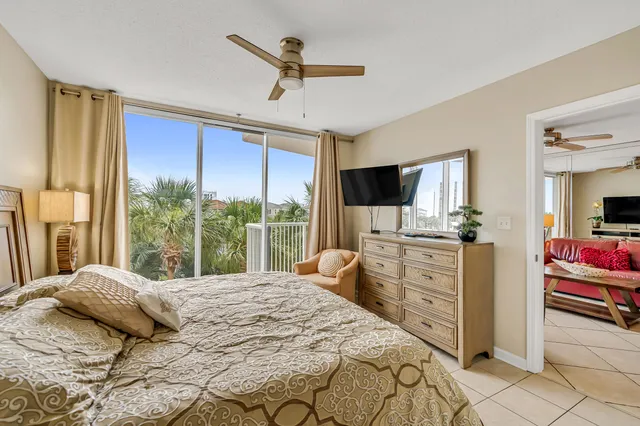 a bedroom with a bed flat screen tv and a large window