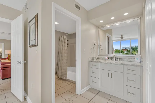 a bathroom with a granite countertop sink mirror and shower