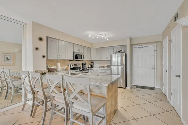 a kitchen with stainless steel appliances a refrigerator sink and cabinets