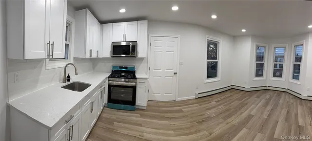 a kitchen with a refrigerator and a sink