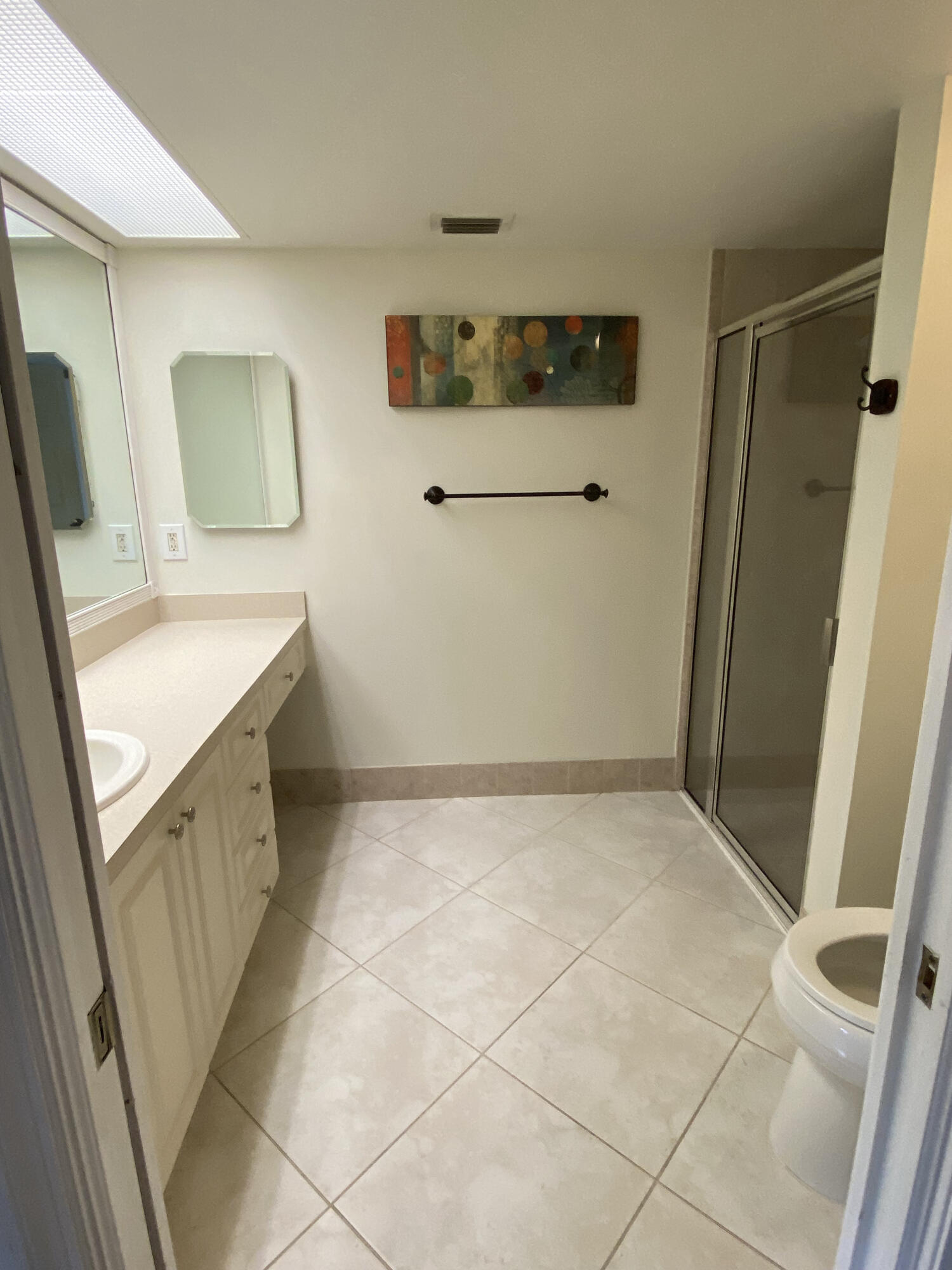 5621 Coach House Circle, Unit D Boca Raton, FL 33486 - Photo 21 of 29 a bathroom with a sink a toilet and mirror