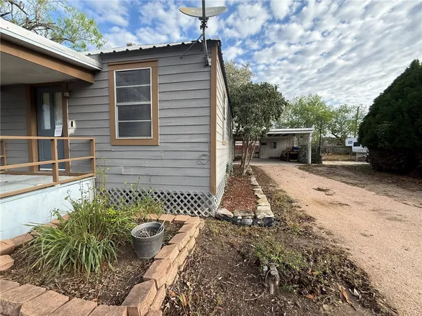 a view of a backyard with sitting area