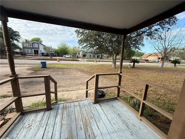 a view of a balcony with wooden floor and outdoor seating