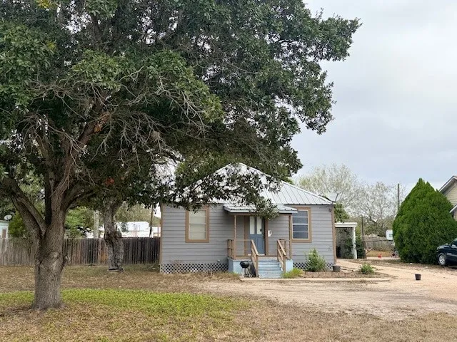 front view of a house with a tree