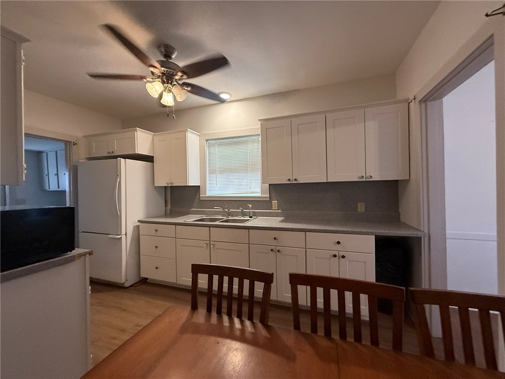 305 East Thornton Street Three Rivers, TX 78071 - Photo 3 of 15 a kitchen with stainless steel appliances white cabinets and wooden floor