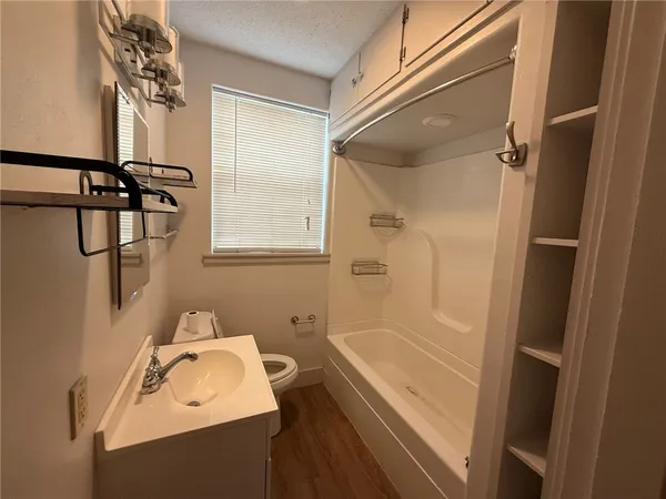 a bathroom with a sink a bathtub and shower