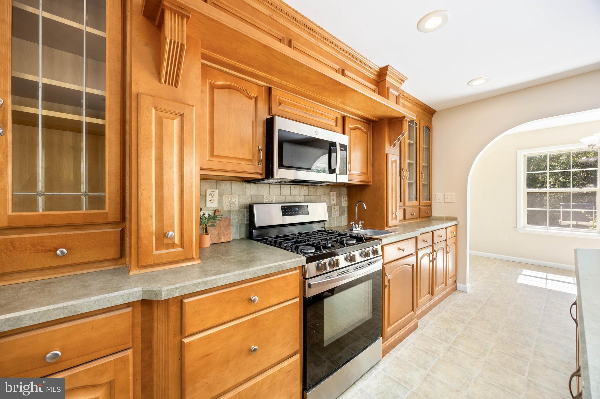 6635 Libertytown Road Berlin, MD 21811 - Photo 18 of 88 a kitchen with stainless steel appliances granite countertop a stove and a microwave